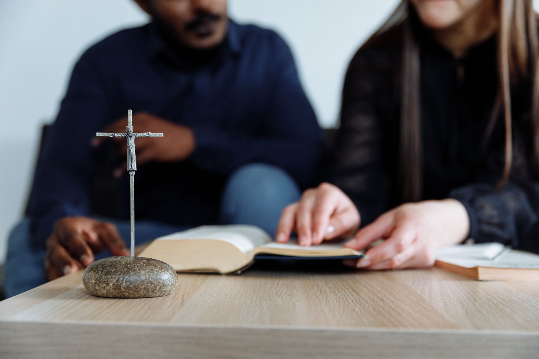 A small group gathered around a table for Bible study and discussion